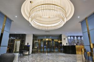 a lobby with a large chandelier in a building at Sahid Zarafshon in Bukhara