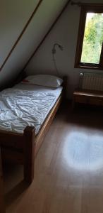 a small bedroom with a bed and a window at Ferienhaus Nr. 60 Im Ferienpark am Twistesee in Bad Arolsen