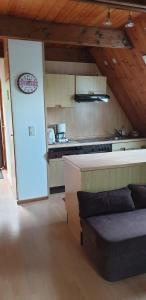a kitchen with a couch in the middle of a room at Ferienhaus Nr. 60 Im Ferienpark am Twistesee in Bad Arolsen
