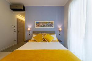 Postel nebo postele na pokoji v ubytování B&B La Piazzetta