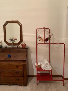 a bathroom with a red towel rack next to a dresser at Apartment De' Ramaglianti in Florence