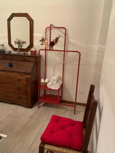 a room with a red ottoman in front of a mirror at Apartment De' Ramaglianti in Florence