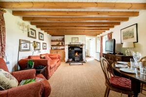 a living room with a couch and a fireplace at Marris Cottage in Grimsby