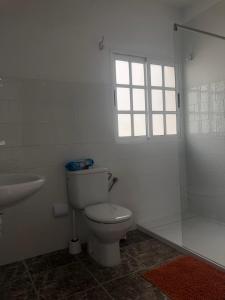 a bathroom with a toilet and a sink and a tub at Apartamentos Elena in Lajares