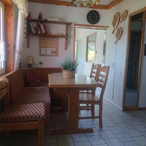a table and chairs in a living room with a couch at Apartamenty Widokowa Korbielów in Korbielów