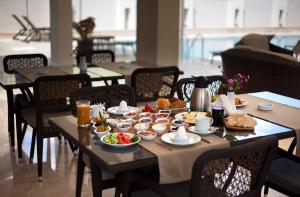 a table with breakfast foods on it in a restaurant at Montana Hotel in Dalyan