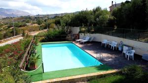 a swimming pool on the side of a house at Le Case Del Vivaio in Sciacca