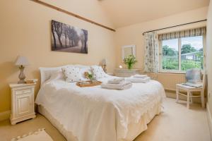 a bedroom with a bed with towels on it at Little Walk Cottage in Grimsby