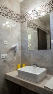 a bathroom with a sink and a mirror at Főnix Apartman in Lenti