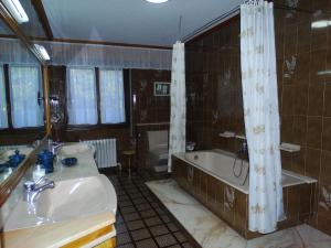 a bathroom with a sink and a tub and a shower at La Casa de la Carpintería in Renedo de Piélagos