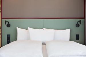 ibis Styles Klagenfurt am Woerthersee客房内的一张或多张床位