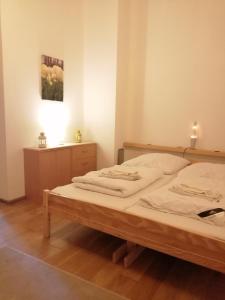 a bedroom with a bed and a table with a lamp at Słonecznikowa Zagroda in Debina