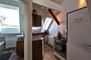 a kitchen with a white refrigerator and a sink at Ferienwohnung Dammerstorf in Dettmannsdorf