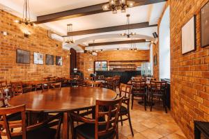 a restaurant with brick walls and tables and chairs at Hotel U Valdické brány in Jičín