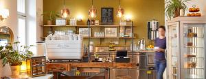 a man standing in front of a kitchen with a counter at Hotel am Chlodwigplatz in Cologne