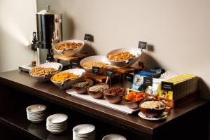 a buffet with bowls of food on a table at Holiday Inn Bristol Filton, an IHG Hotel in Bristol