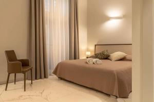 a bedroom with a bed and a chair in it at Il Pozzo Magico in Venice