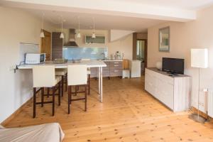 a kitchen with a table and chairs in a room at Ferienwohnung Zimmert in Zimmert
