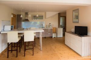 a kitchen with a table with chairs and a television at Ferienwohnung Zimmert in Zimmert +27 photos