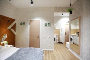 a bedroom with a large bed and a bathroom at REHOME 24 in Tyumen