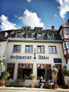 two people sitting in front of a building at Schwarzer Adler in Michelstadt