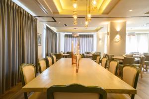 a conference room with a long wooden table and chairs at Emerald Suites in Florina