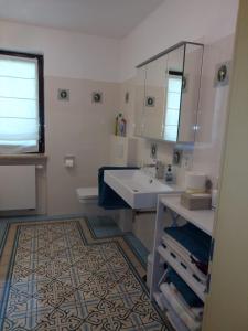 a bathroom with a sink and a mirror at Ferienwohnung Nöll in Regensburg