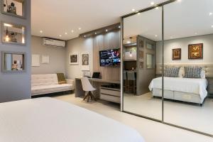 a bedroom with a bed and a sliding glass door at Gym | Food Hall | 450m from the mall #CA04 in Florianópolis