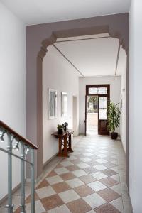a hallway with white walls and a staircase with a table at B&B Borgo Castello in Marostica