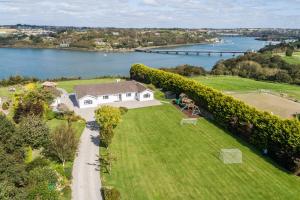 an aerial view of a house on a lawn next to a river at Marina views, Kinsale, Exquisite holiday homes, sleeps 20 in Kinsale