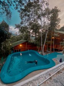 a person swimming in a swimming pool at Utan Teluk Nipah in Pangkor