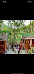 a person standing in front of a house at Utan Teluk Nipah in Pangkor