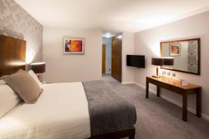 a hotel room with a bed and a desk at Hotel Kilkenny in Kilkenny