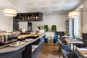 a restaurant with a buffet line with tables and chairs at Corte Calzaiuoli Elegant Suites in Florence