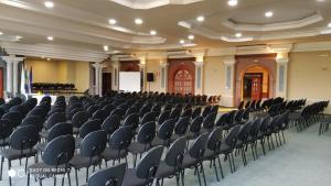 a large hall with chairs and a podium in it at Virgilius Palace Hotel in Araxá