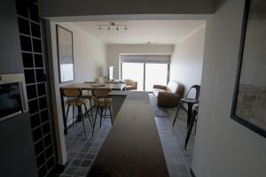 a living room with a table and chairs at Appartement Caraibes 8ste verdieping in Blankenberge