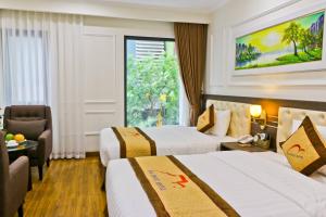 a hotel room with two beds and a window at Dai Phat Luxury Hotel & Apartment in Hanoi