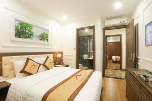 a bedroom with a large bed and a bathroom at Dai Phat Luxury Hotel & Apartment in Hanoi