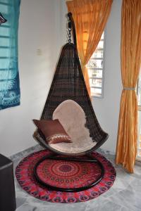 a basket with pillows and a hat on a rug at PD Ohana Holiday home at Cocobay Resort PortDickson in Port Dickson