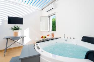 uma grande casa de banho branca com uma grande banheira em Masseria Ancella em Montalbano