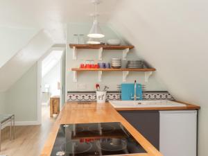 a kitchen with a sink and a stove top oven at Ella's Loft in Canterbury