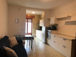 a kitchen with a couch and a table in a room at Porto di Ponza - Immobilevante in Ponza