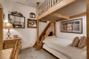a bedroom with a bunk bed and a staircase at Corral at Breckenridge #102E - Access to Hot Tub - Close to Town in Breckenridge