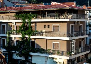an apartment building with a balcony in a city at Toti Boutique Rooms in Kalabaka