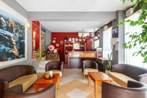 a restaurant with couches and tables in a room at Toti Boutique Rooms in Kalabaka
