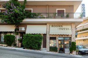 a store front of a building with a balcony at Toti Boutique Rooms in Kalabaka