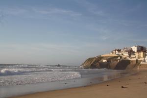 a beach with a group of houses and the ocean at São Pedro de Moel by Campigir in São Pedro de Moel