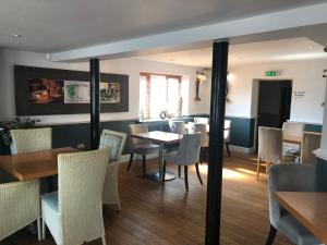 a restaurant with tables and chairs and a dining room at The Elm Tree Inn in Wisbech