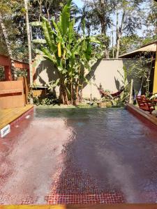 a pool of water in front of a house at Magias de Paraty Ecopousada in Paraty
