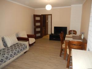 a living room with a couch and a table at LERA APARTMENT in Burgas City